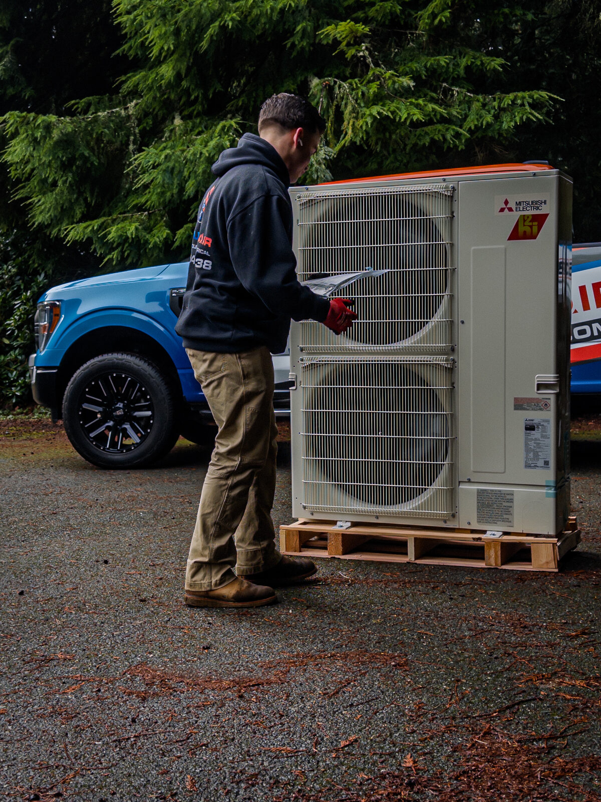 Mitsubishi Electric heat pump ready for install with a Product Air truck behind it